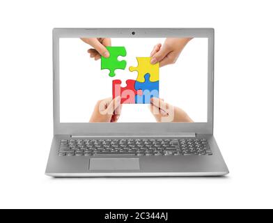 Hands and puzzle in computer notebook Stock Photo