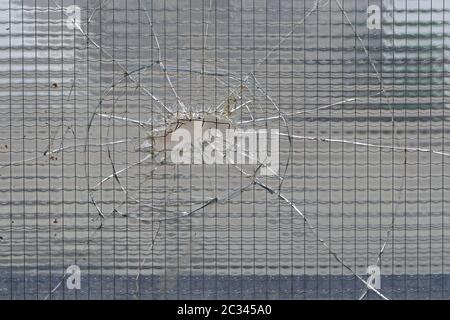 Cracked safety tempered glass with big hole Stock Photo