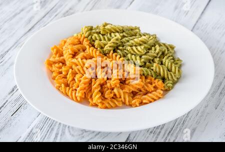 Portion of fusilli pasta with traditional and tomato pesto Stock Photo