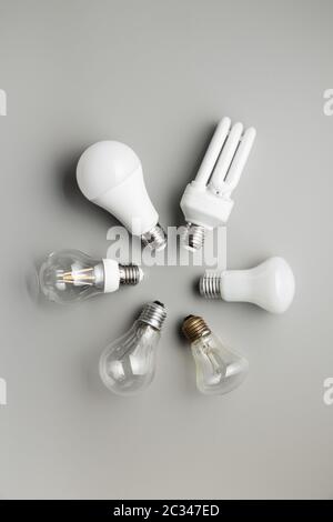 Energy saving and classic light bulbs on gray background. Top view. Stock Photo