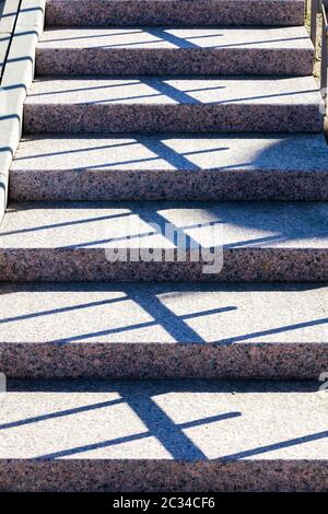 part and close-up of concrete stairs on the street, a real new design with shadows from the railing, Sunny day Stock Photo