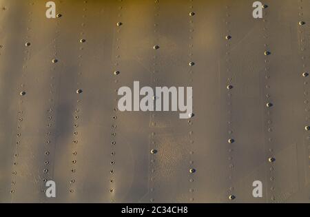 the metal structure is completely covered with rows of rivets Stock Photo