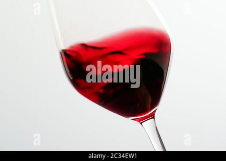 Glass of red wine, pouring drink at luxury holiday tasting event, quality control splashing liquid motion background for oenolog Stock Photo