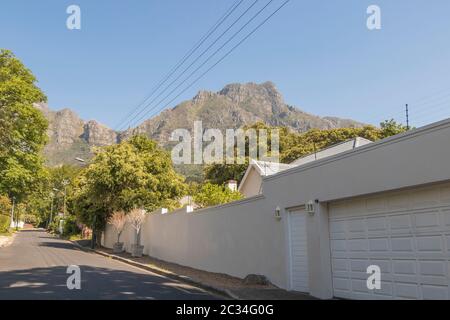 Street in the town of Claremont, Cape Town, South Africa. Sunny weather and panorama of Table Mountains. Stock Photo