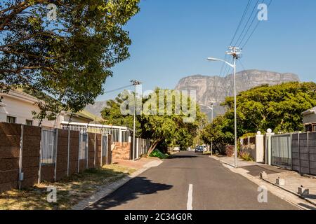 Street in the town of Claremont, Cape Town, South Africa. Sunny weather and panorama of Table Mountains. Stock Photo