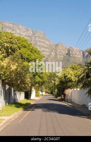 Street in the town of Claremont, Cape Town, South Africa. Sunny weather and panorama of Table Mountains. Stock Photo