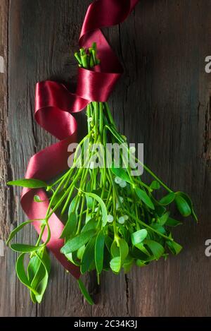 Fresh mistletoe hanging on a red ribbon on white background Stock Photo ...