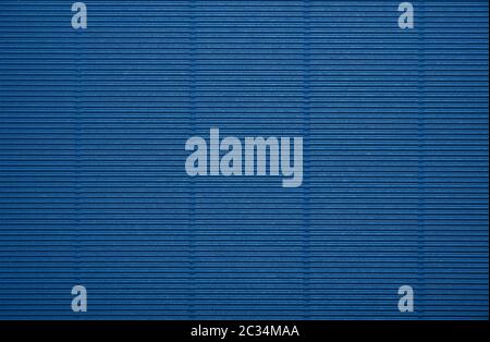 Close up background pattern texture of dark blue corrugated packaging cardboard Stock Photo