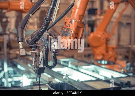robotic arm for automated production of components for the automotive industry. Stock Photo