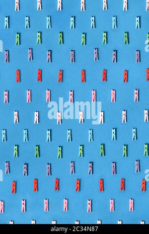 Colored clothespins pattern on a blue. Stock Photo