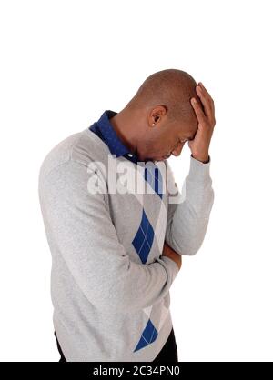 A young handsome African American man standing waist up in the studio with one hand on his forehead, isolated for white background Stock Photo
