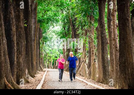 happy asian senior couple jogging together at morning Stock Photo