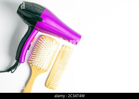 Professional hairdresser's set on white background, top view. Hairdryer, hair brushes, combs. Stock Photo