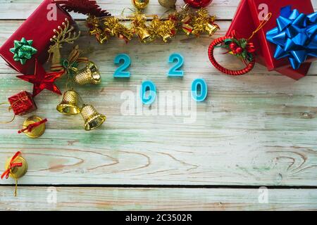 Here are Christmas tree decorations and many bright red gift boxes. Placed on a beautiful wooden table To prepare to celebrate the Christmas holidays Stock Photo