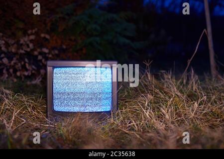 White noise on an analogue TV set in outdoor environment Stock Photo