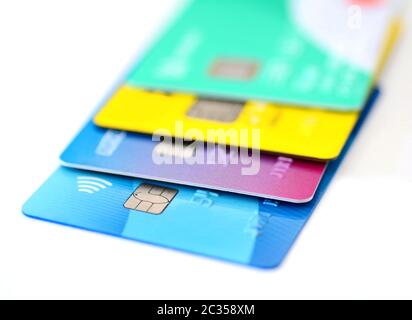 Stack of multicolored credit cards collection on white background. Stock Photo