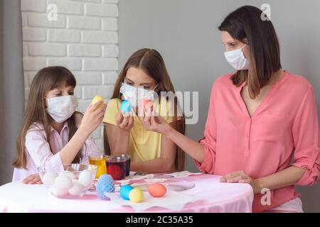 Mom and two quarantined daughters painted eggs for Easter Stock Photo