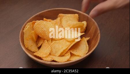 Having potato chip at party Stock Photo