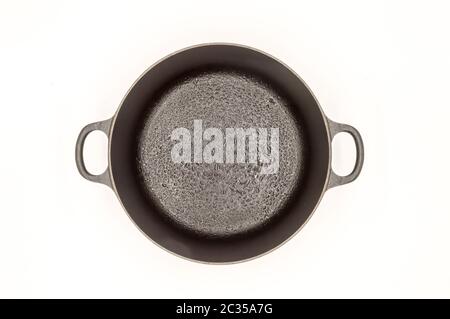 Cast iron pan with two handles top view on a white background Stock Photo