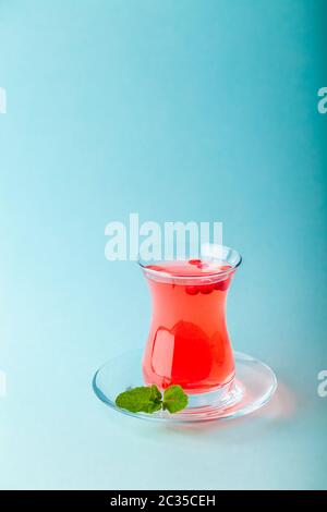 Fresh fruit red tea in transparent turkish teacup