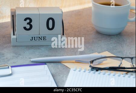 June 30, date on the calendar. Handmade wood cube with date month and day.  Stock Photo