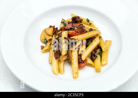 Spaghetti aglio e olio, pasta with dried chili and bacon. Italian cuisine. Stock Photo