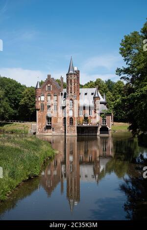 Bazel, Belgium, June 1, 2020, Wissekerke Castle a moated castle with the reflection in the water Stock Photo