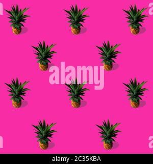 trend pattern with pineapples on a bright pink background, the concept of minimalism Stock Photo