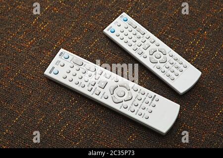 Remote controls on a dark table Stock Photo