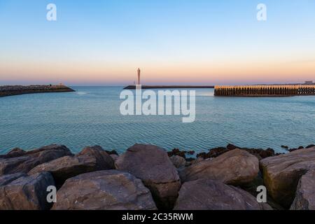 The harbor entrance of Oostende (Ostend) with its three piers at sunset, North Sea, West Flanders, Belgium. Stock Photo