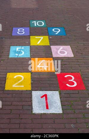 Colourful Hopscotch Playground Markings Numbers at Pavement Stock Photo