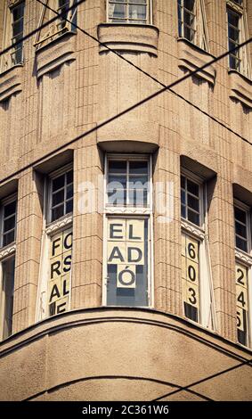 Close up shot of a building, windows framed by the electric tram cables. Close up shot of a random building in Budapest, Hungary. Stock Photo