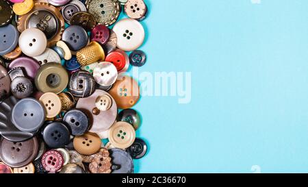 top view of many of various buttons on blue background with blank copyspace Stock Photo
