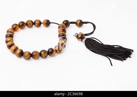 worry beads from tiger's eye gemstones on white paper background Stock Photo