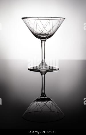 Liqeur glass with ornaments in backlight with reflection Stock Photo
