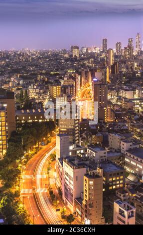 Aerial view of Korakuen illuminated streets in the night of Tokyo with Ikebukuro skyscrapers in back Stock Photo