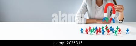 Businessperson Attracting Human Figures With Horseshoe Magnet Stock Photo