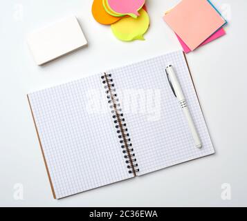 open notebook with blank white sheets, color stickers and rectangular business cards on a white background, top view, flat lay Stock Photo
