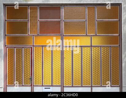 Yellow privacy glass door with decorative structure Stock Photo