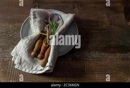 Vintage set of cutlery knife, spoon, fork with linen napkin on the plate. Stock Photo