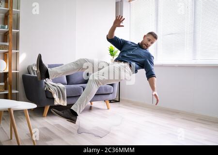 Man Slipping And  Falling At Home Stock Photo