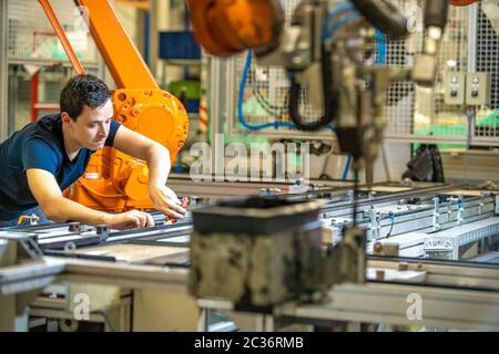 installation of new robot arms in the factory for modernization of production. Stock Photo
