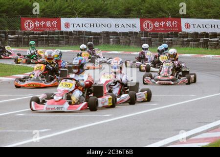 Kart racers speeding along the track corner. Stock Photo