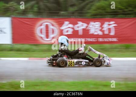 Kart racers speeding along a track corner. Stock Photo