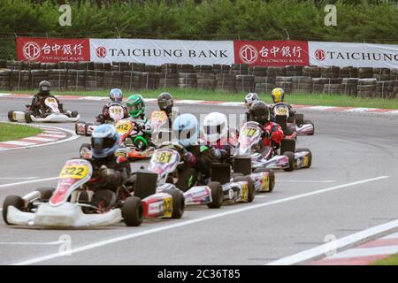 Kart racers speeding along the track corner. Stock Photo