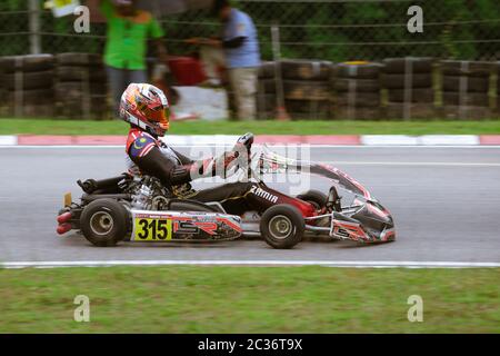 Kart racers speeding along a track corner. Stock Photo
