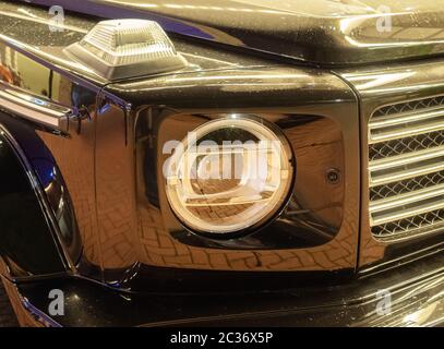 Close-up photo of headlights on a black shiny car Stock Photo