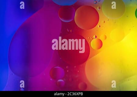 Oil drops in water. Abstract defocused psychedelic pattern image rainbow colored. Abstract background with colorful gradient colors. DOF Stock Photo