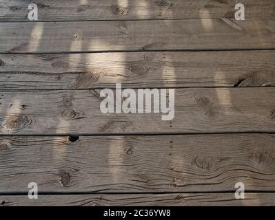 Untreated and weathered wooden beams on a very old veranda Stock Photo