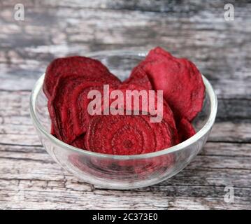 Dried beets in a glass cup on a wooden background Stock Photo